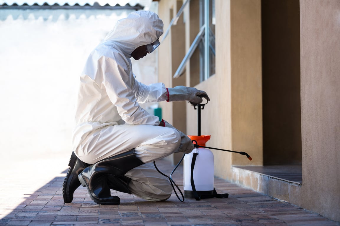 Side view of a man doing pest control